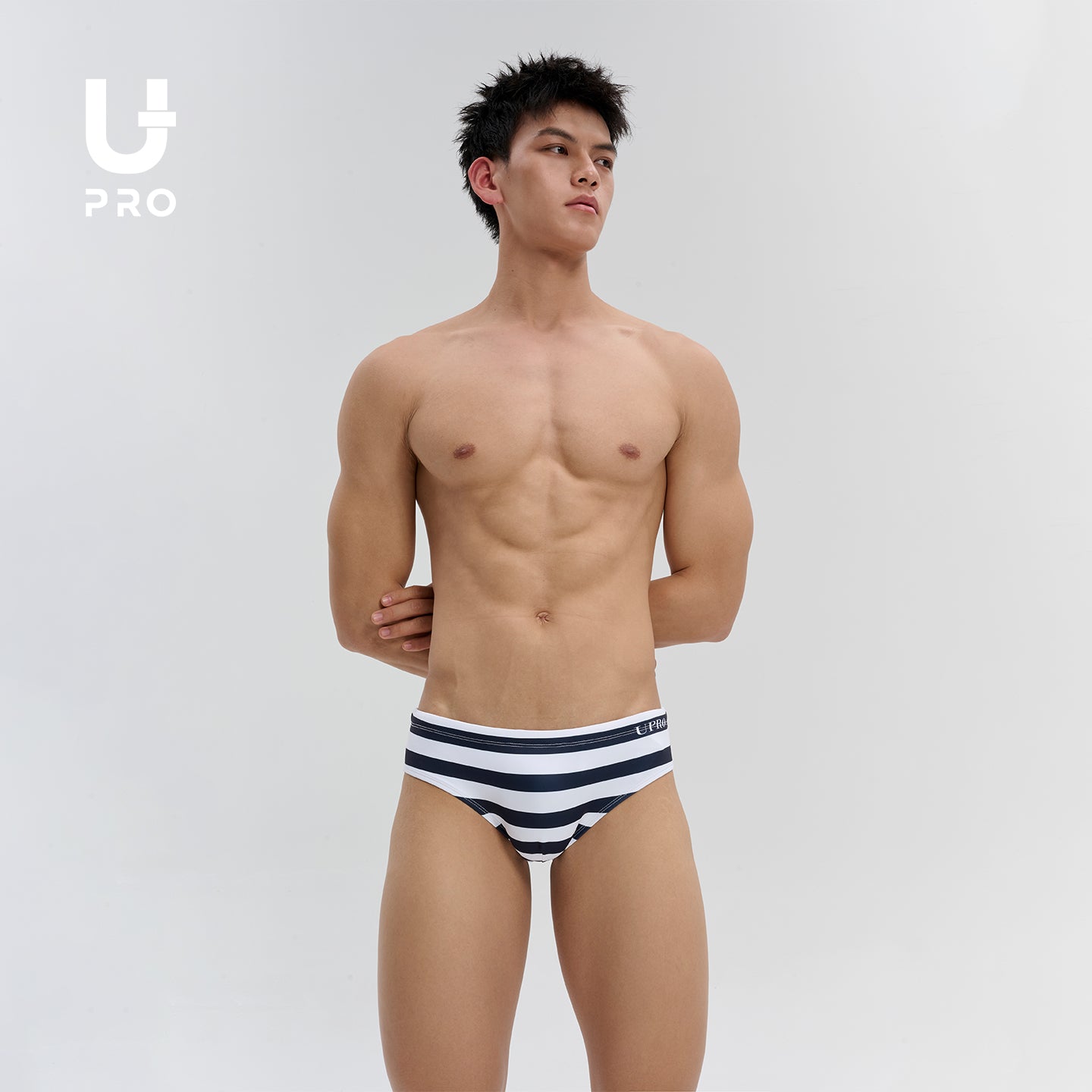 UPRO model wearing black-and-white striped swim briefs