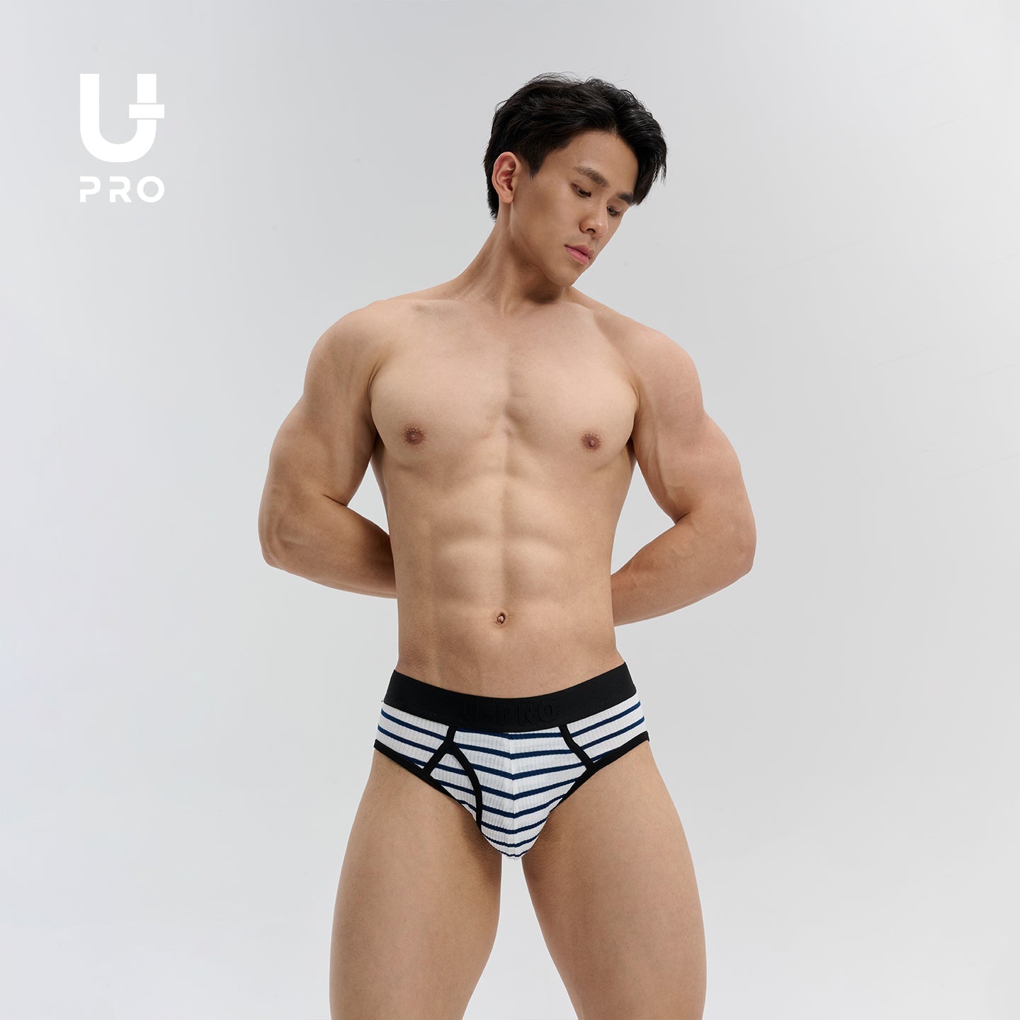 UPRO model wearing blue-and-white striped briefs with a black waistband
